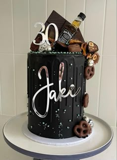 a 30th birthday cake decorated with chocolate, pretzels and cookies