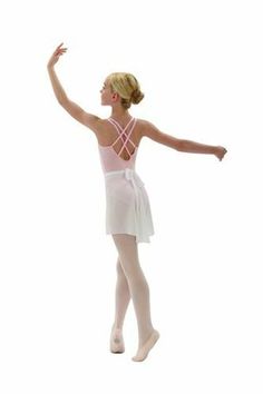 a young ballerina in white is posing for the camera with her arms outstretched and feet apart