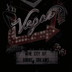 the sign for vegas is lit up in the dark with light bulbs on it's sides