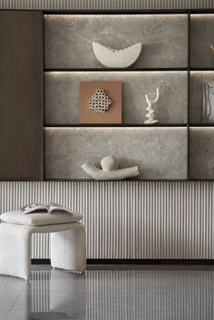 a white bench sitting in front of a wall with vases and other items on it