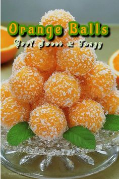 orange balls in a glass bowl with leaves on the top and words orange balls gourmet e - shop