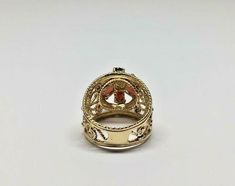 Vintage 14k Yellow Gold Wide Filigree Oval Garnet & Round Pearl Ring Size 6.5 Metal: 14k yellow gold, stamped Weight: 6.6 grams Ring size: 6 1/2 (can be resized upon request) Width: 17mm wide (at widest points) Stones: Center round pearl aprx. 2.60mm, 6 oval garnet stones aprx. 5mm x 3mm Hallmarked: 14k This is an estate piece in very good condition. Please see pictures for reference. Gold Oval Gemstone Filigree Ring, Ornate Gold Oval Filigree Ring, Gold Oval Filigree Ring Fine Jewelry, Ornate Yellow Gold Oval Filigree Ring, Oval Yellow Gold Filigree Ring Stamped 14k, Gold Oval Filigree Collectible Ring, Garnet Stone, New City, Multi Stone Ring