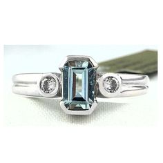 Carat: 14k Solid White Gold (Not Plated) Gem Type: 1 Genuine Aquamarine - 0.78 Carats Aquamarine Grades: Hue . . . Blue Tone . . . Medium Saturation . . . Vivid 2 Genuine Diamonds - 0.12 Carats Total Diamond Grades: Color . . . H Clarity . . . Si2 Ring Size: 8 (Free Resizing Service - If Needed) Shape: Emerald Cut & Round Type Of Setting: Bezel & Channel Net Weight: 2.6 Grams Dimensions: 7 Mm X 5 Mm - Aquamarine Measurements Anniversary Blue Topaz Diamond Ring Gia Certified, Gia Certified Blue Topaz Anniversary Ring, Gia Certified Blue Topaz Diamond Ring For Anniversary, Platinum Blue Ring With Bezel Setting, Blue Platinum Rings With Bezel Setting, Beautiful Gold Rings, Blue Tone, Etsy Gold Ring, 14k White Gold Ring