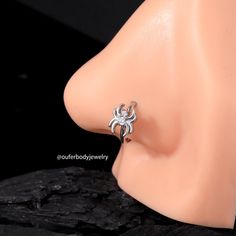 a close up view of a fake head with a spider ring on it's ear