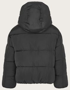 Snow day essentials.With a classic puffer finish, cosy hood, and pockets, this coat is ideal for keeping them warm during snowball fights. It features an all black design, making it the perfect term time coat.As part of the journey to make our clothes kinder to the world around us, this item was made using more sustainable raw materials, such as organic cotton, recycled polyester and viscose from responsibly grown forests.  Black Fluffy Bag, Hood Girls, Short Puffer Jacket, Black Puffer Coat, Year 7, Black Puffer Jacket, Boys Accessories, Kids Coats