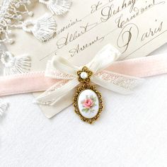 This coquette style choker necklace is handmade with a soft double sided blush pink velvet ribbon. It features a vintage lace and silk satin ribbon bow, pearl bead jewel and a beautiful vintage ceramic cameo with a sweet pink rose. A lovely gift for women who love to wear romantic historical style jewelry.  See last photos for coordinating designs available separately in the Rosy Posy Designs shop... a fun group gift for mothers, daughters, sisters and friends! * Size ~ Adjustable length 12 - 15 Pink Velvet Ribbon, Rosy Posy, Ribbon Choker, Coquette Style, Satin Ribbon Bow, Fun Group, Beaded Jewels, Cameo Pendant, Unique Handmade Jewelry