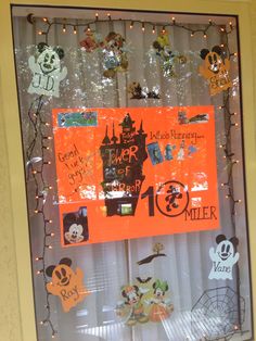 a mickey mouse bulletin board is decorated with halloween magnets and paper cutout characters