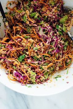 a white bowl filled with coleslaw and carrots