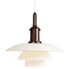 a white light hanging from the ceiling with a brown and white lamp on it's side