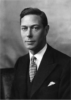 a black and white photo of a man in a suit