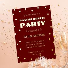 this is a bachelor party card with confetti on the table and champagne glasses