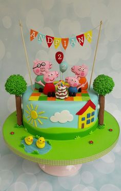 a birthday cake with three peppo pigs on it