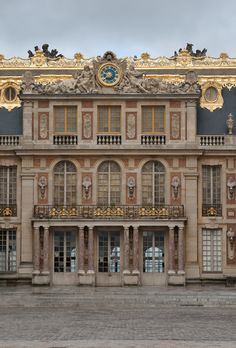 an ornate building with gold trim and windows