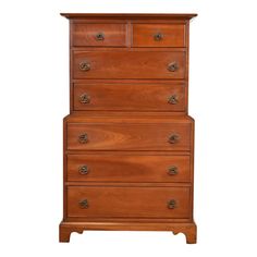 a wooden dresser with four drawers and two pulls on the bottom drawer, against a white background