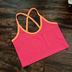 Never Worn. Excellent Condition. Size Small. Cropped Fit Pink Color Block Tops For Vacation, Sporty Pink Tops For Vacation, Sporty Pink Top For Vacation, Pink Workout Tops For Summer, Pink Color Block Top For Summer, Pink Summer Workout Tops, Summer Pink Color Block Tops, Pink Sporty Tops For Beach, Cheap Orange Crop Top