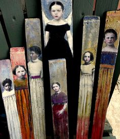 an assortment of painted wooden clothes pegs with pictures of women in dresses on them