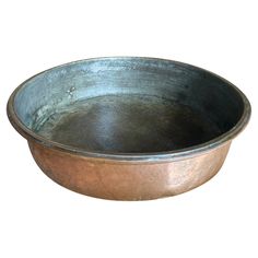 a large metal bowl on a white background