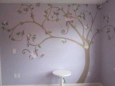 a bathroom with a tree painted on the wall