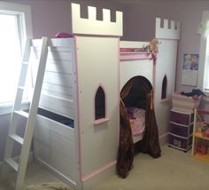 a child's bedroom with a castle bed and bunk beds