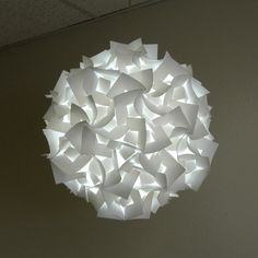 a white light hanging from the ceiling in a room with no one around it or someone else