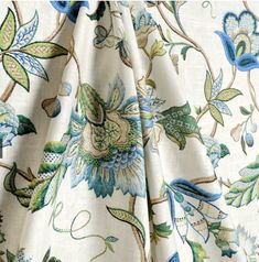 the fabric has blue and green flowers on it