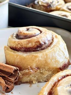 cinnamon rolls with icing on a white plate