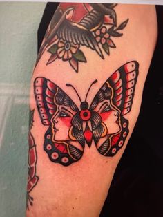 a woman's arm with a butterfly tattoo on it