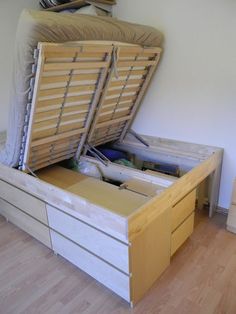 a bed with two drawers and a mattress on top