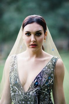 a woman in a dress with a veil on her head