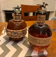 two bottles of liquor sitting on top of a table