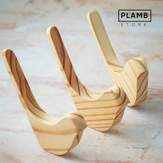 two wooden spoons sitting next to each other on a table