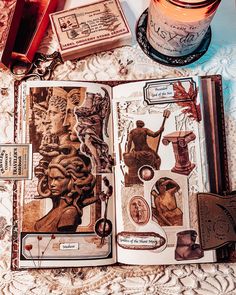 an open book sitting on top of a table next to a jar of liquid and other items