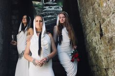 three women dressed in white standing next to each other