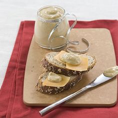 two pieces of bread on a cutting board with butter