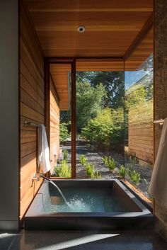 an outdoor jacuzzi tub in the middle of a room