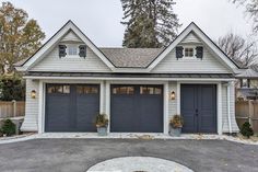 two garages in front of a white house