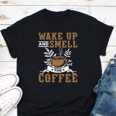 Wake Up And Smell The Coffee Shirt, Coffee Girl Shirt, Coffee Lover Shirt, Funny Coffee Shirt, Morning Coffee Shirt, Coffee Addict Shirt Ordering Process for our valued customers ~ Please follow all steps to place an order. ~ Please select the hoodie type and size. ~ Please select color of the hoodie from drop down options. ~ If you want to purchase more than 1 , add current item to your cart and then you can click back, add more items for each product. ~ Once all your desired items , you can co Coffee Short Sleeve Shirt With Letter Print, Coffee Colored Short Sleeve Shirt With Letter Print, Funny Coffee Shirts, Coffee Tees, Coffee Girl, Coffee Shirts, Coffee Humor, Coffee Addict, Shirt Price