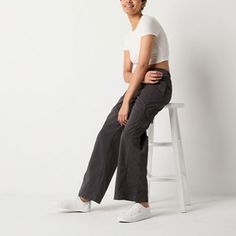 These Arizona women's low-rise cargo pants are a stylish utilitarian pair to sport for off-duty days. Made from 100% cotton, this wide-leg style has a baggy-fit, drawstring waist and side slip pockets. Team it with a tank top or a graphic tee. Front Style: Flat FrontClosure Type: Full ElasticFit: Baggy FitPockets: 2 Side Slip PocketsRise: Low RiseBase Material: 100% CottonFiber Content: 100% CottonFabric Description: WovenLining: UnlinedInseam: 32 InLeg Style: Wide LegCare: Machine WashCountry o Everyday Sporty Cargo Bottoms, Sporty Everyday Cargo Bottoms, Sporty Everyday Cargo Style Bottoms, Utility Cotton Mid-rise Parachute Pants, Sporty Everyday Cargo Pants, Sporty Mid-rise Cargo Pants With Pockets, Sporty Mid-rise Cargo Pants, Mid-rise Cotton Cargo Parachute Pants, Mid-rise Cotton Everyday Cargo Pants