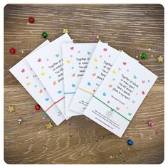 five personalised birthday cards with confetti scattered around them on a wooden table