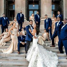 a group of people in formal wear posing on steps