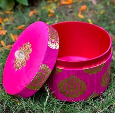 two pink bowls sitting on top of green grass