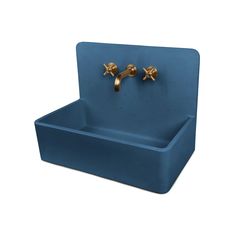 a blue sink with two gold faucets on the top and one in the middle