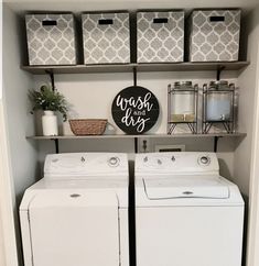 a washer and dryer sitting in a room next to shelves with baskets on them