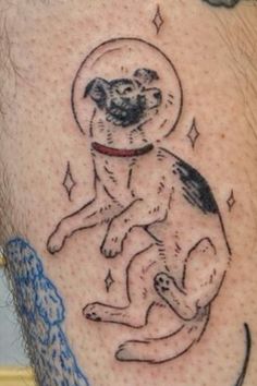 a man with a dog tattoo on his leg