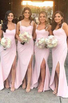 the bridesmaids are all wearing pink dresses with thigh high slits and holding bouquets