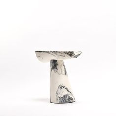 a white and black marbled object on a white background with no one around it