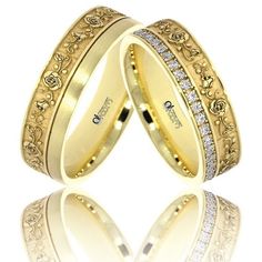 two gold wedding rings with diamonds on them