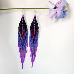 New color combination Seed Bead Earrings 5 inch long.Flowing beads earrings.The predominant colors are Black,Dark Purple,Sparkling blue,Fuchsia,Orange color . Sterling silver ear wire.Different shades of colors seamlessly blend into each other.These are luxurious earrings for every day and also for an evening out. Materials; Japanese seed beads. Czech seed beads. sterling silver 925 plated ear wire. Weight Earrings( 6g) Purple Beaded Fringe Earrings For Festivals, Purple Bohemian Jewelry With Black Beads, Bohemian Purple Jewelry With Black Beads, Purple Beaded Dangle Earrings With Black Beads, Purple Dangle Beaded Earrings With Black Beads, Bohemian Purple Chandelier Earrings With Ear Wire, Purple Dangle Earrings With Black Beads, Purple Beaded Festival Earrings, Purple Beaded Dangle Earrings For Festival