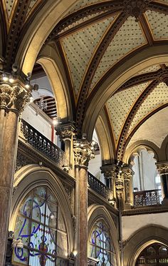 the inside of a building with many windows and arches on each side of the ceiling