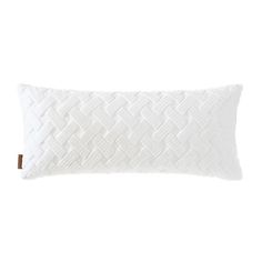 the white pillow is made from cotton and has a braided design on it's side